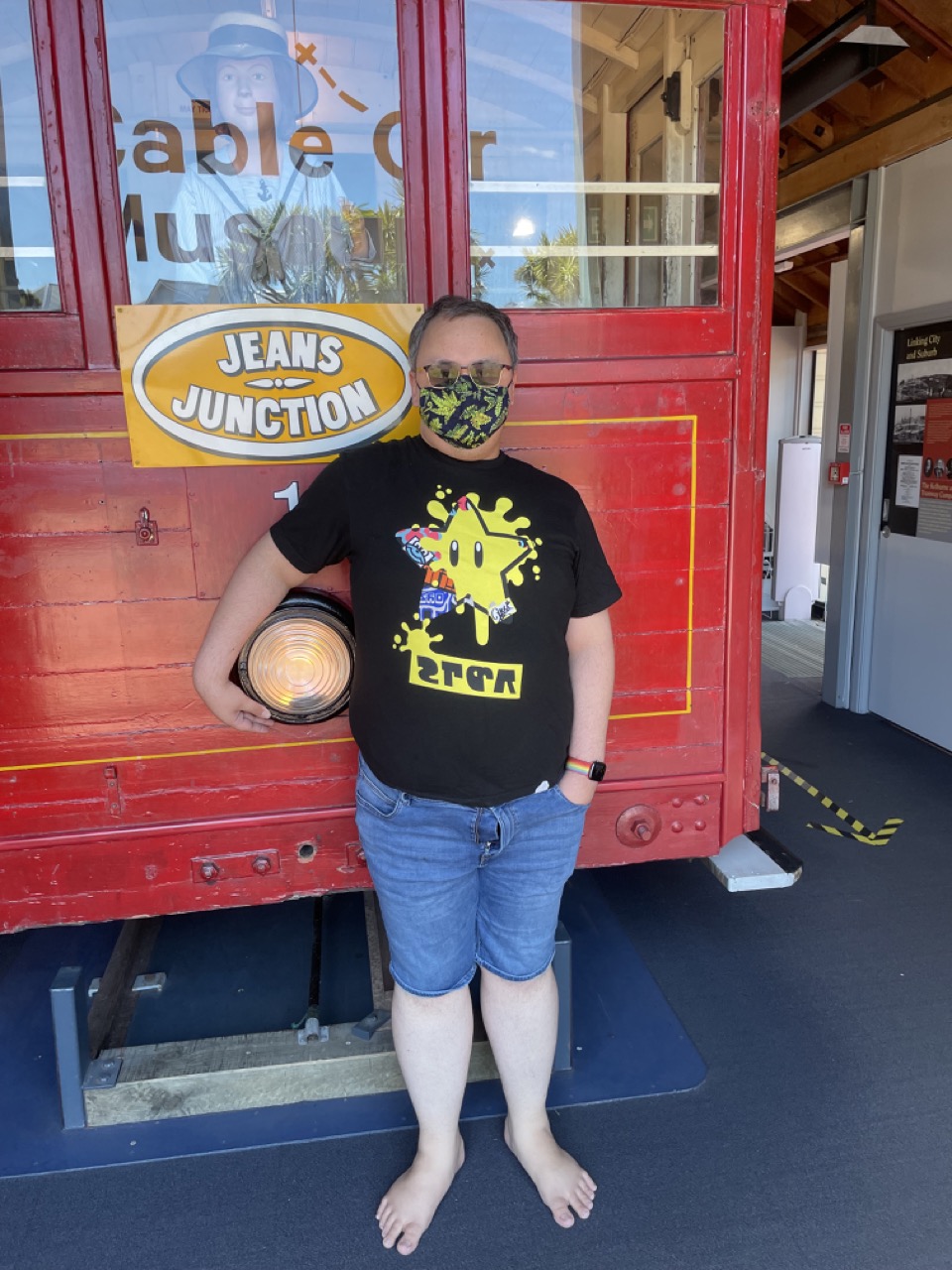 Feets leans against a disused cable car inside the museum, his hand wrapped around the front lamp