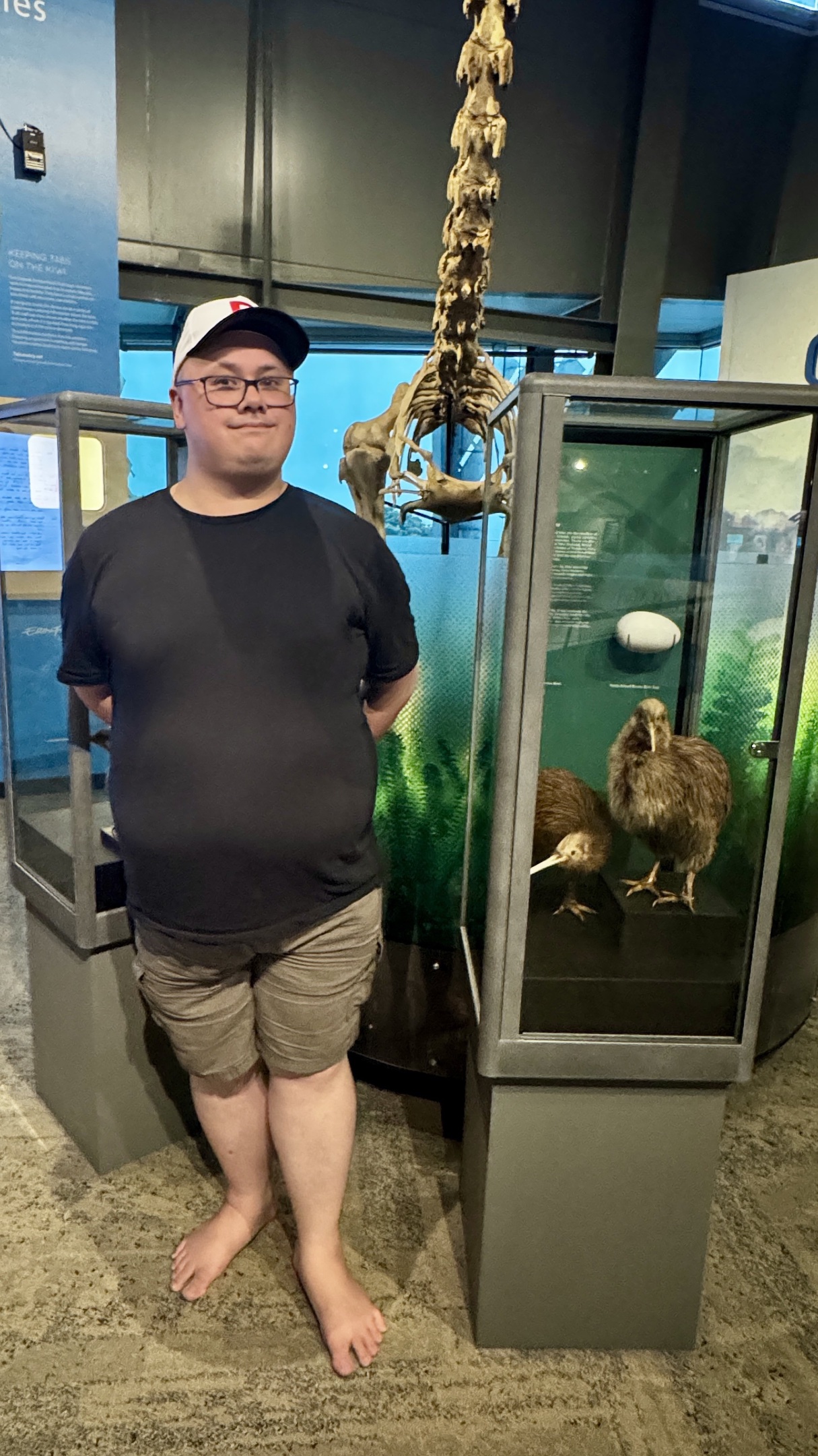 Feets standing in front of some kiwi models.